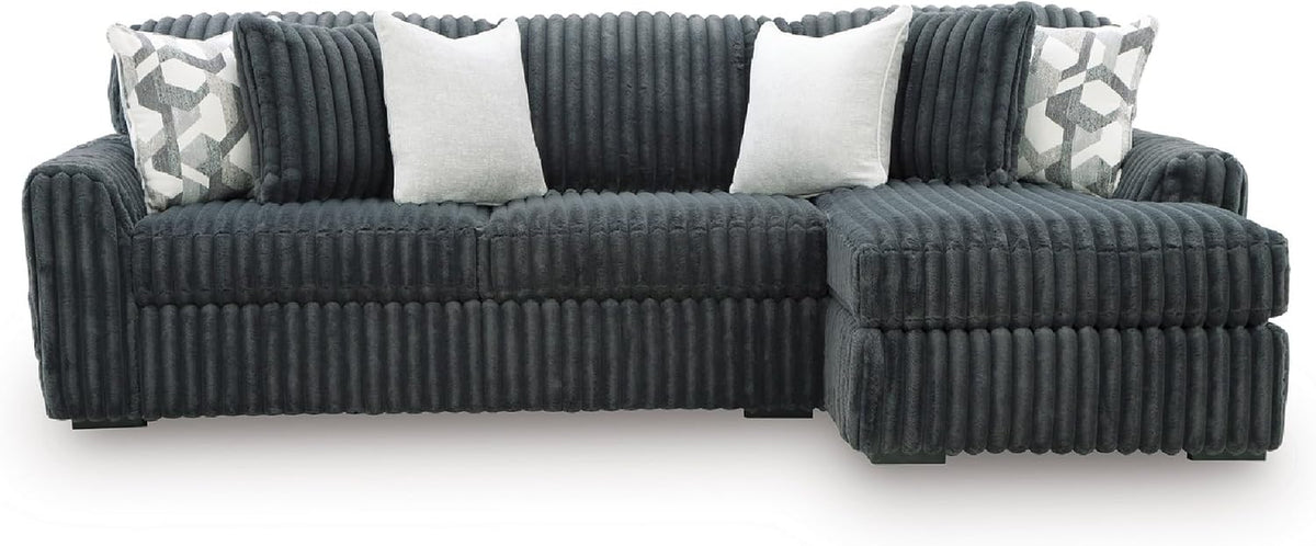 Front view of a dark gray oversized chaise sofa with matched pillows and ribbed corduroy texture