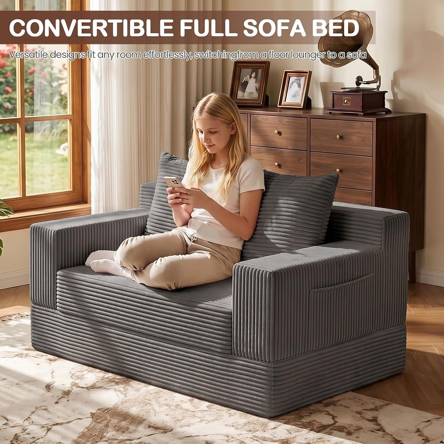 Girl sitting on a single gray corduroy loveseat positioned by a window and wooden dresser
