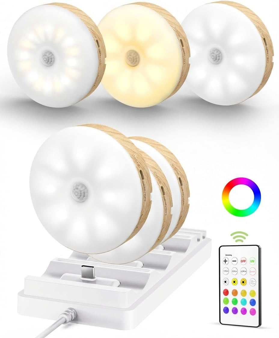 Front view of three puck lights with wood-effect side trim showing warm and cool light tones above the charging base and