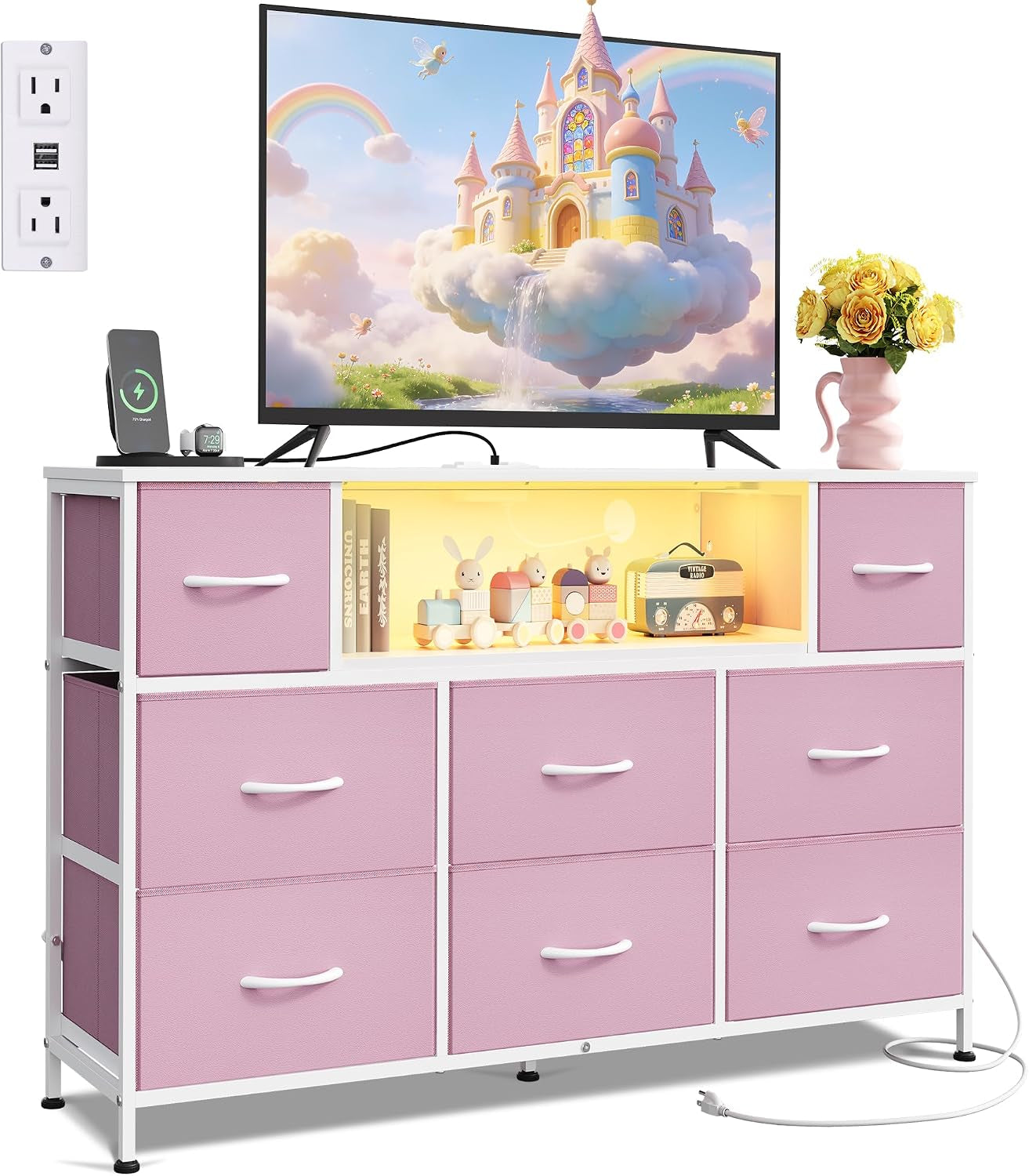White-framed dresser with pink fabric drawers and glowing center shelf displaying toys under a TV.