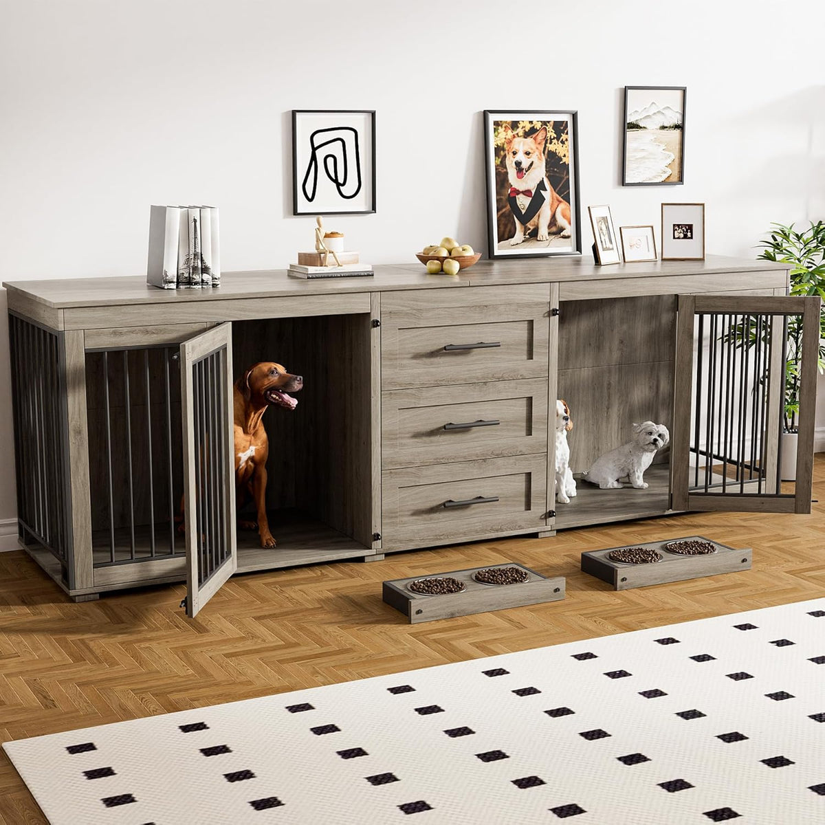 Light gray wooden double dog crate TV stand with open doors, brown dog in left compartment and two small white dogs right.