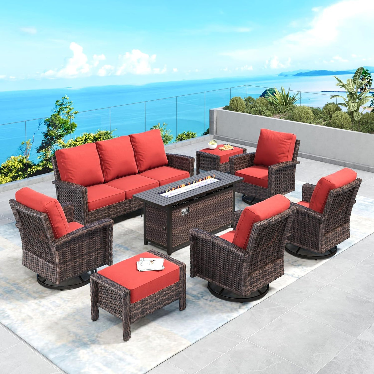 Patio set with bright red cushions around a rectangular fire table, sofa and swivel chairs on a terrace.