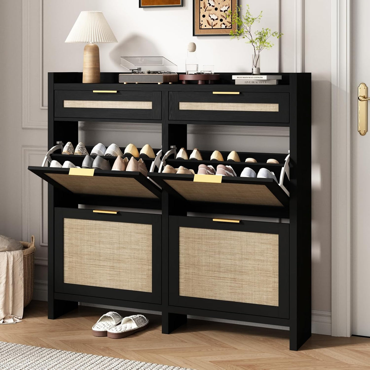 Black shoe cabinet with both lower flip drawers open showing pairs of shoes, lamp and record player on top.