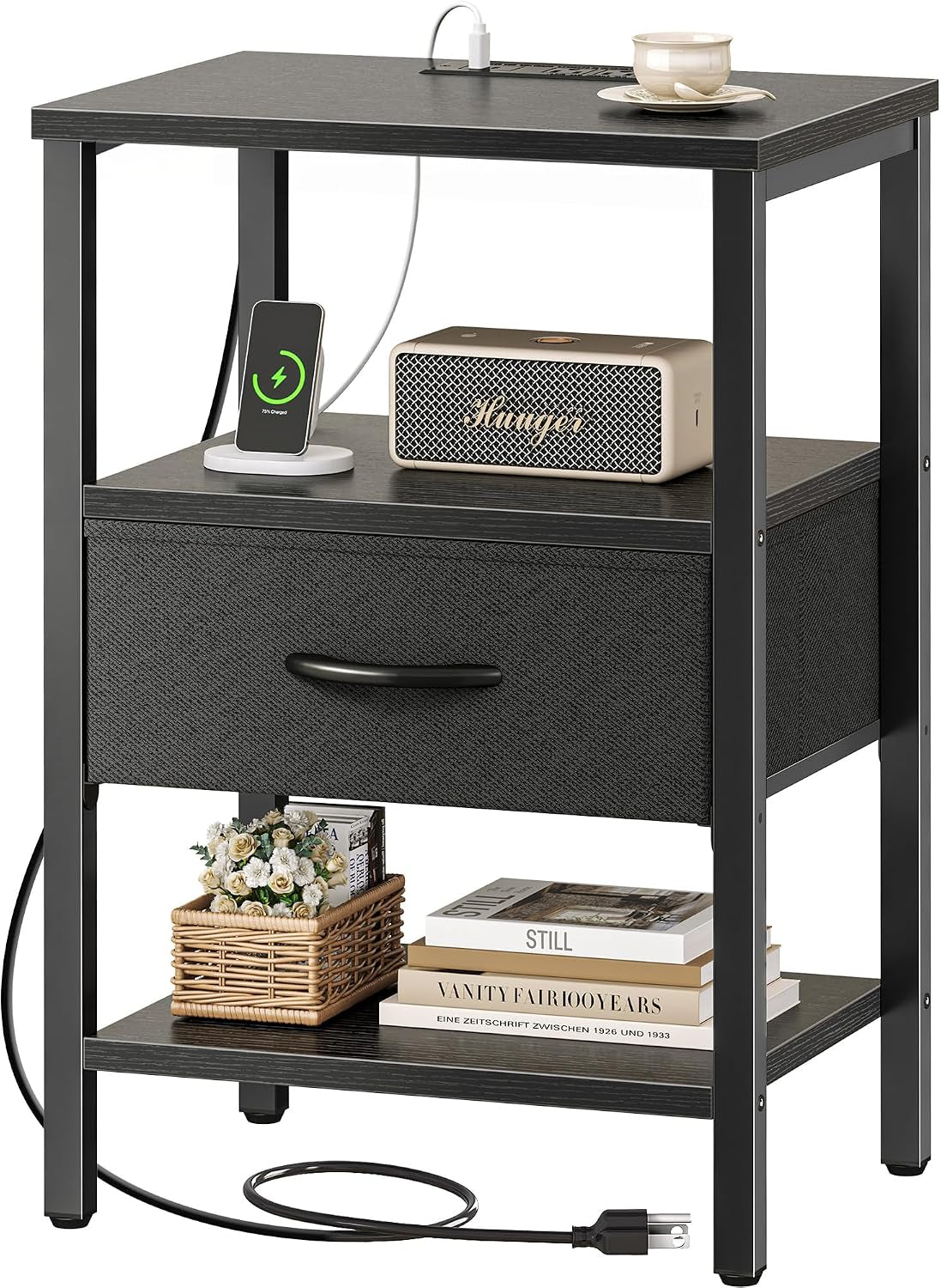 Black frame nightstand with black wood top, open shelf, fabric drawer and bottom shelf, charger cord visible