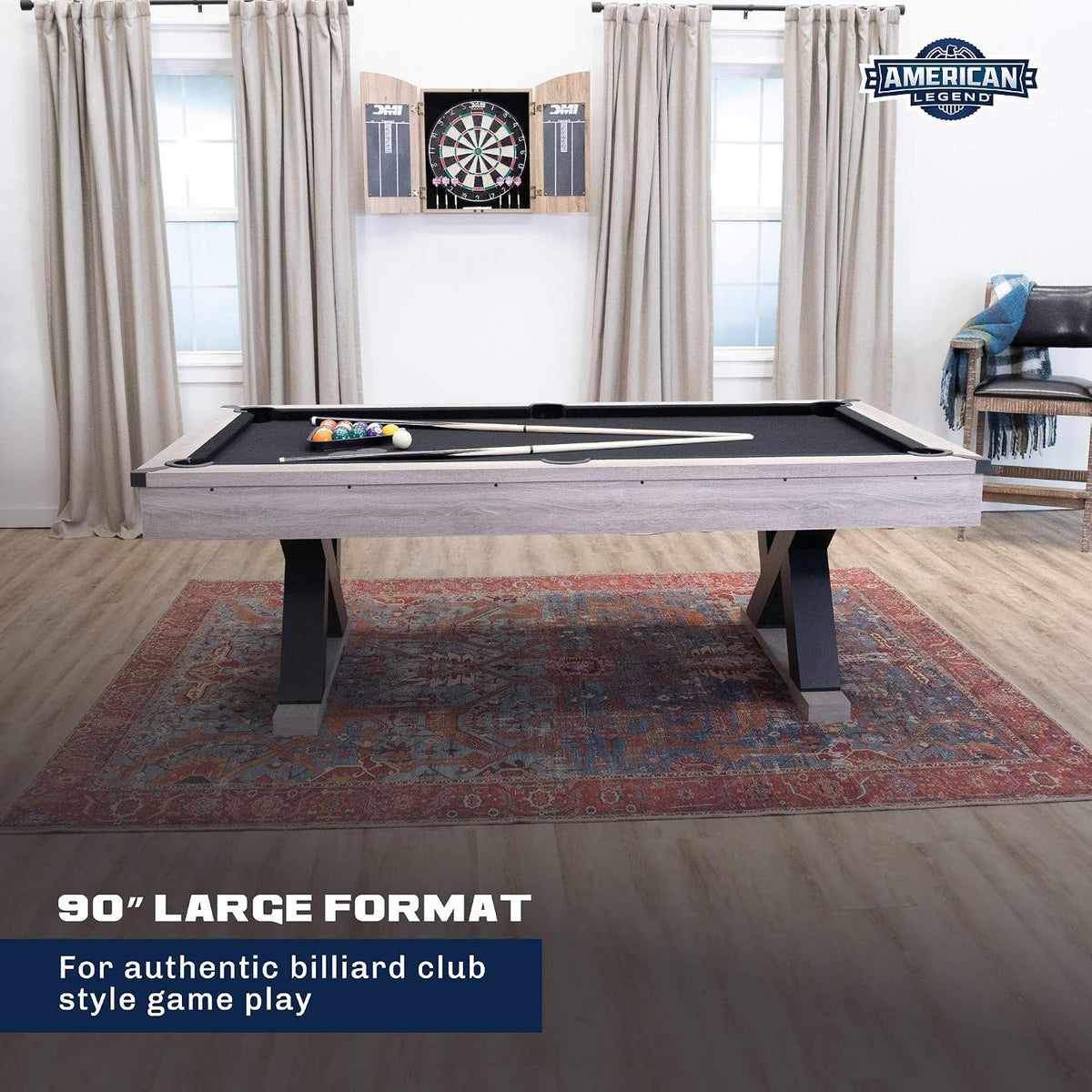 Straight-on front view of the 90-inch billiard table with black cloth centered in a living room on a patterned rug.