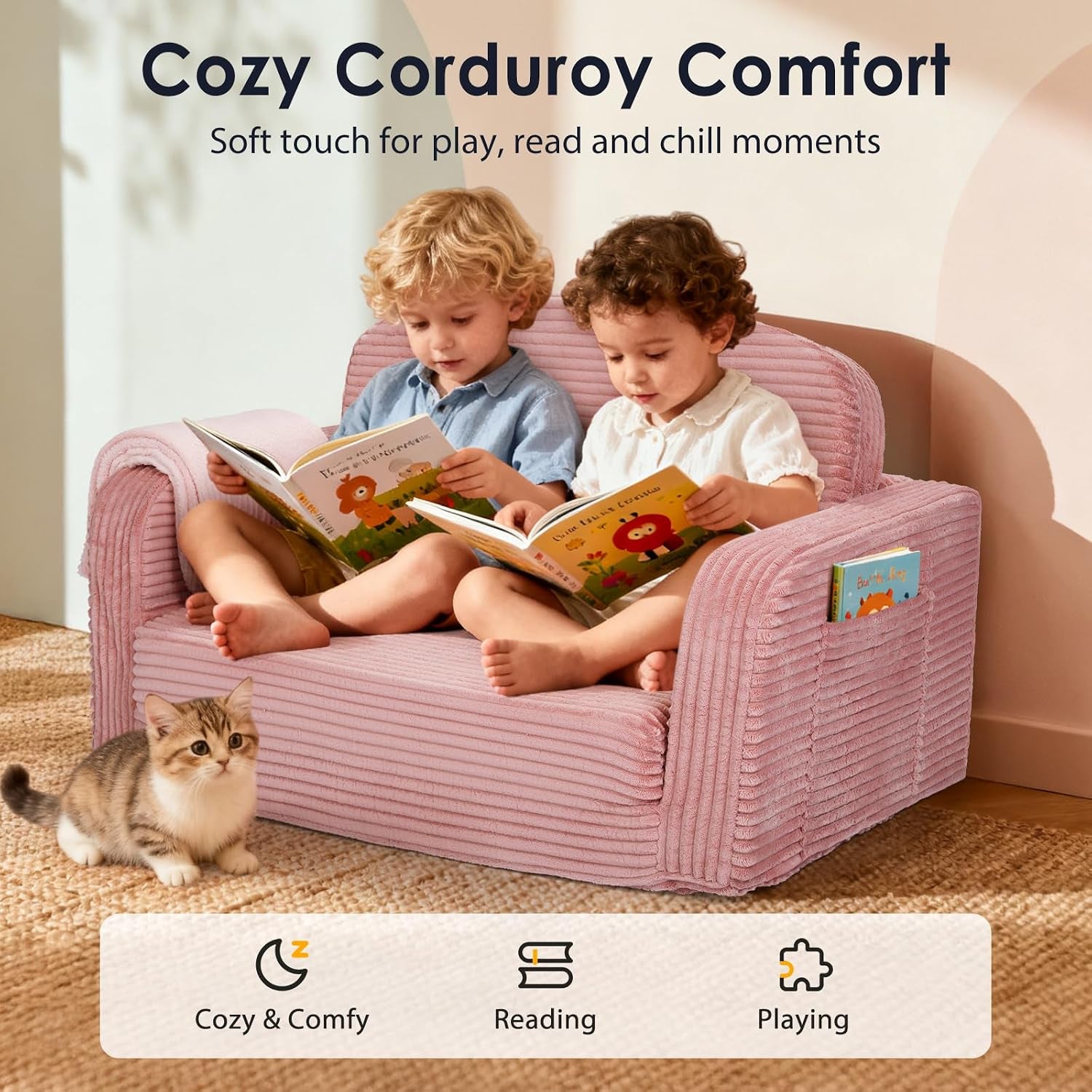 Two children sitting on the pink corduroy sofa with a small cat nearby and a book pocket visible on the arm.
