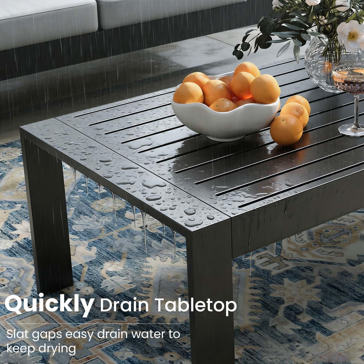 Rectangular slatted aluminum tabletop with water droplets showing an outdoor table surface