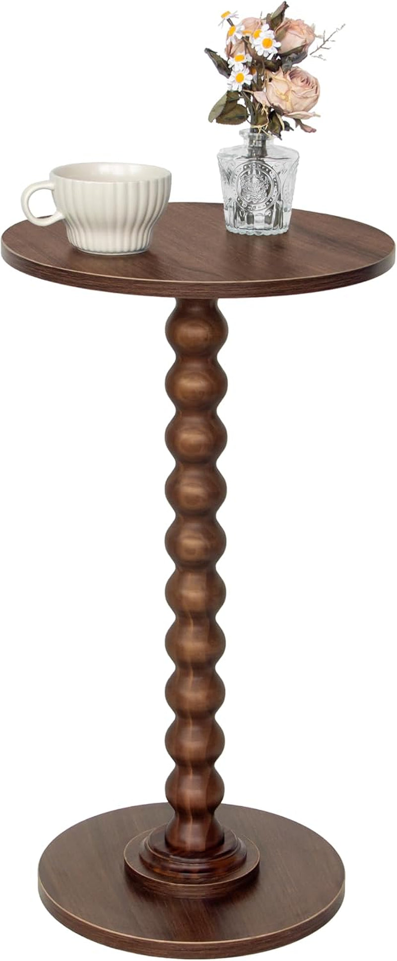 Dark brown round side table with textured wood top, vase and mug shown