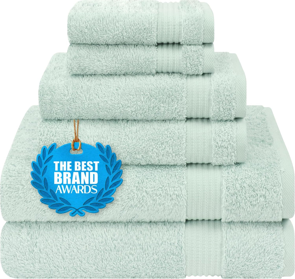 Front view of pale mint-green towels stacked with a blue award medallion hanging on the front