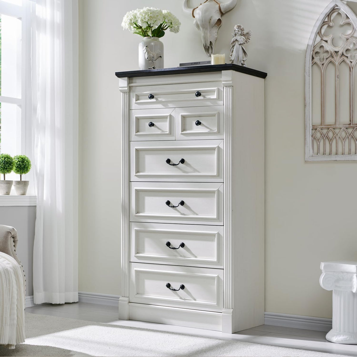 Tall white farmhouse 7-drawer dresser with dark wood top, angled front view in a bright bedroom