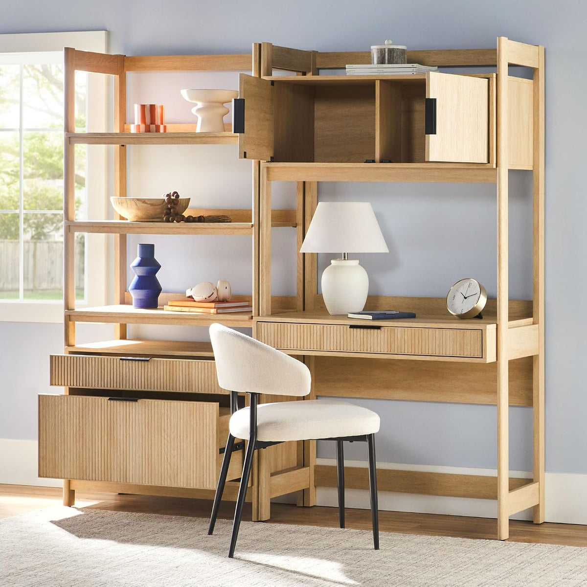Two-piece set in a room scene with the upper hutch doors open and a chair positioned at the desk surface.