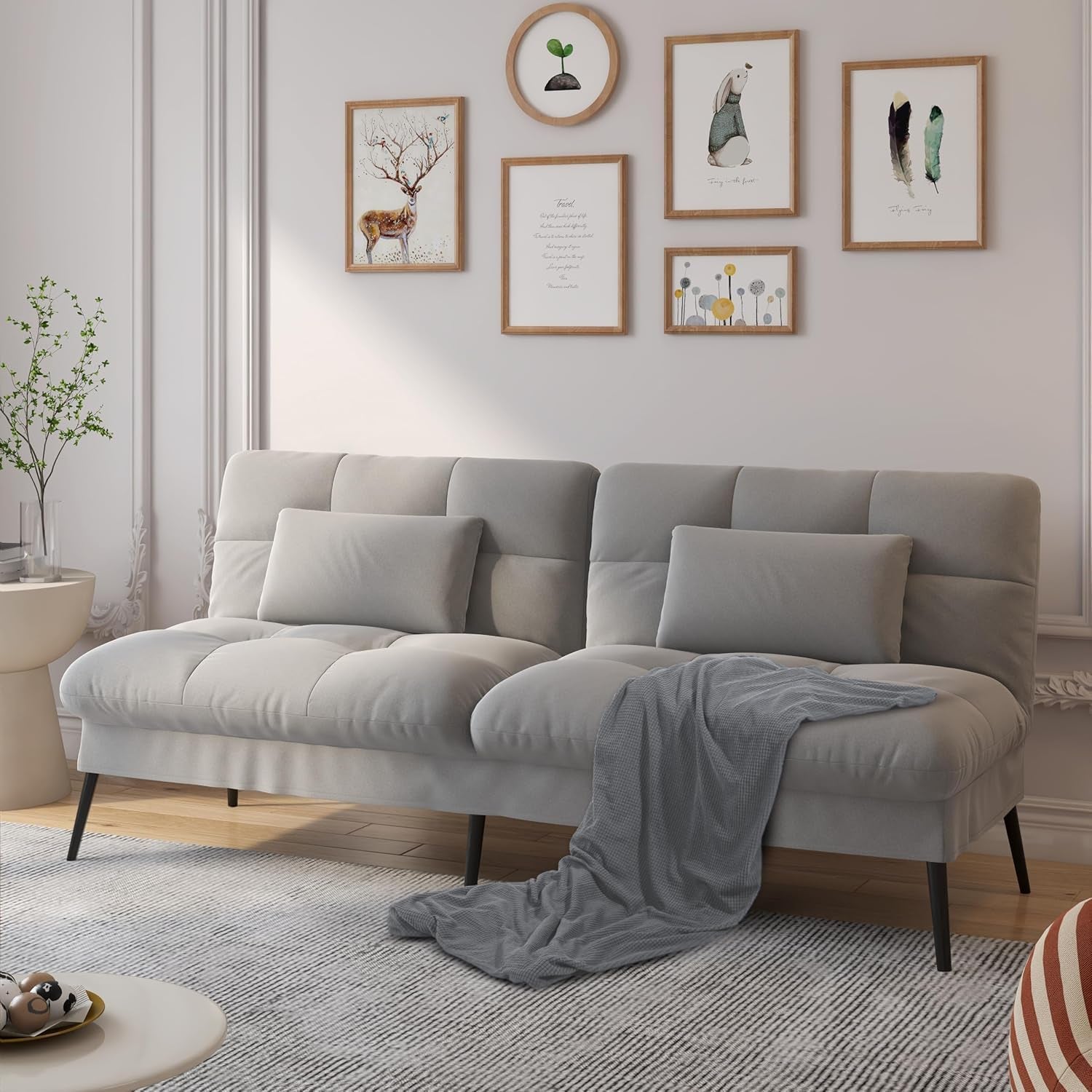 Grey fabric convertible futon sofa set in a living room angled front view with two lumbar pillows