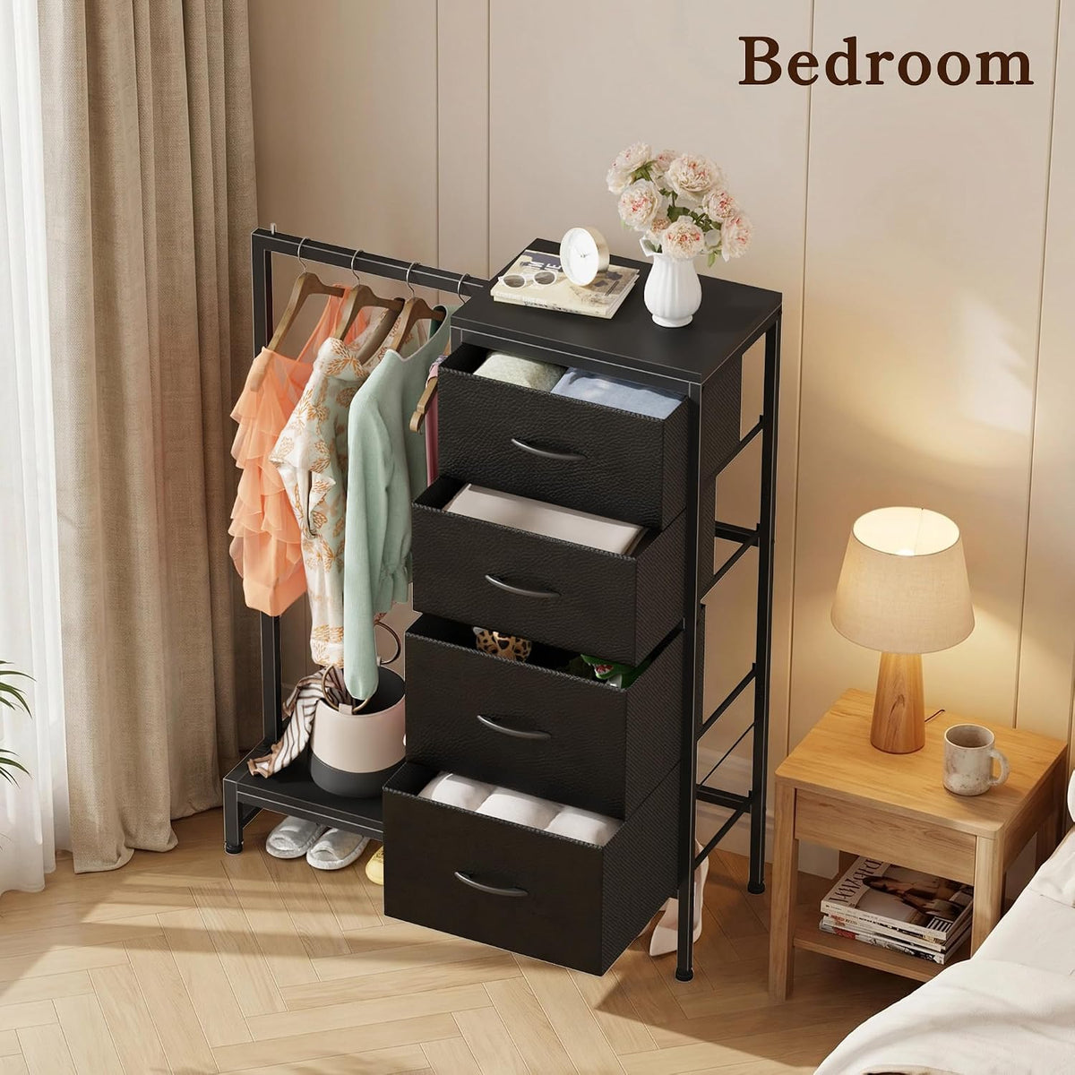 Top-side angle of the black dresser with open drawers and the adjacent hanging bar displayed next to a bedside lamp