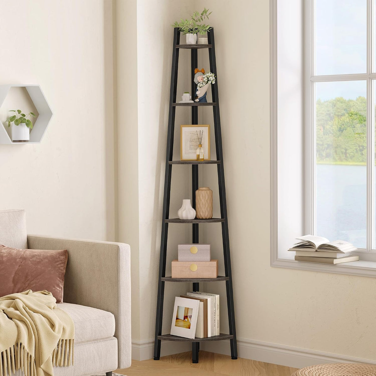 Close crop of the black shelf showing middle tiers with framed art, reed diffuser and textured vases.