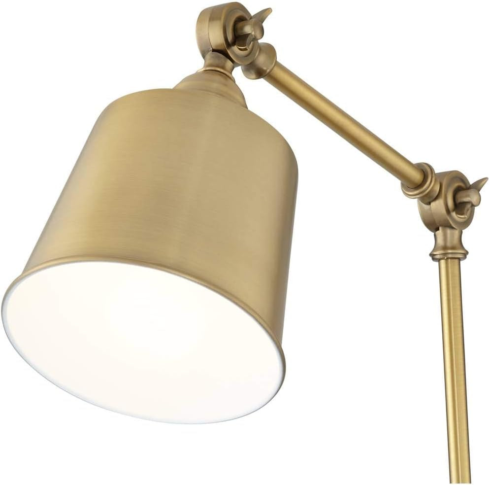 Close-up of antique brass downlight shade angled to show white interior diffuser and brushed metal finish