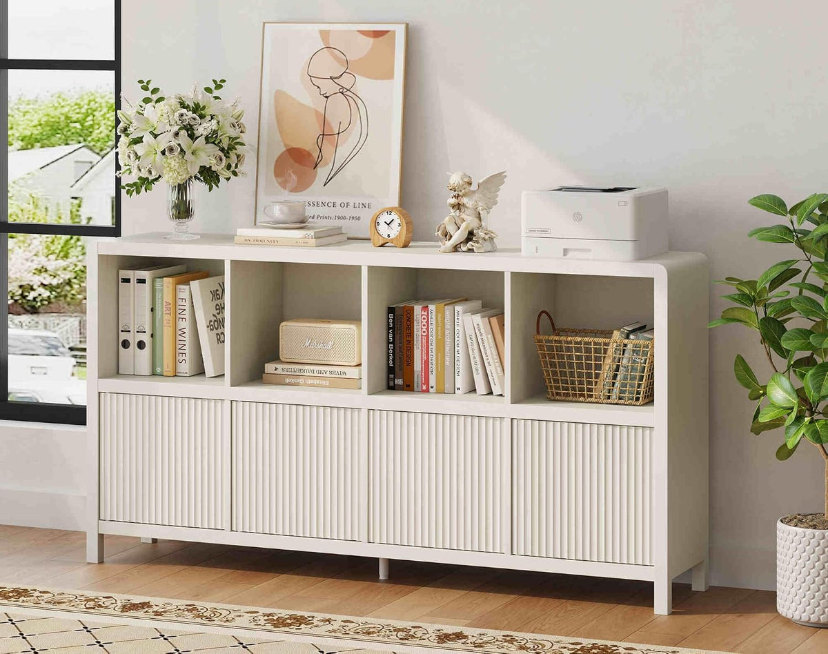 White low bookcase with ribbed front doors and cubbies filled with books and basket, printer on top