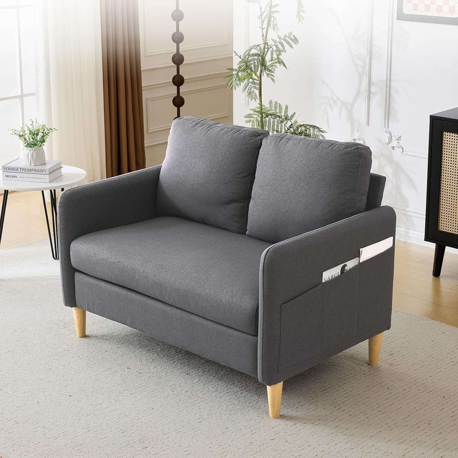 Dark-gray loveseat angled to show two back cushions and wooden legs