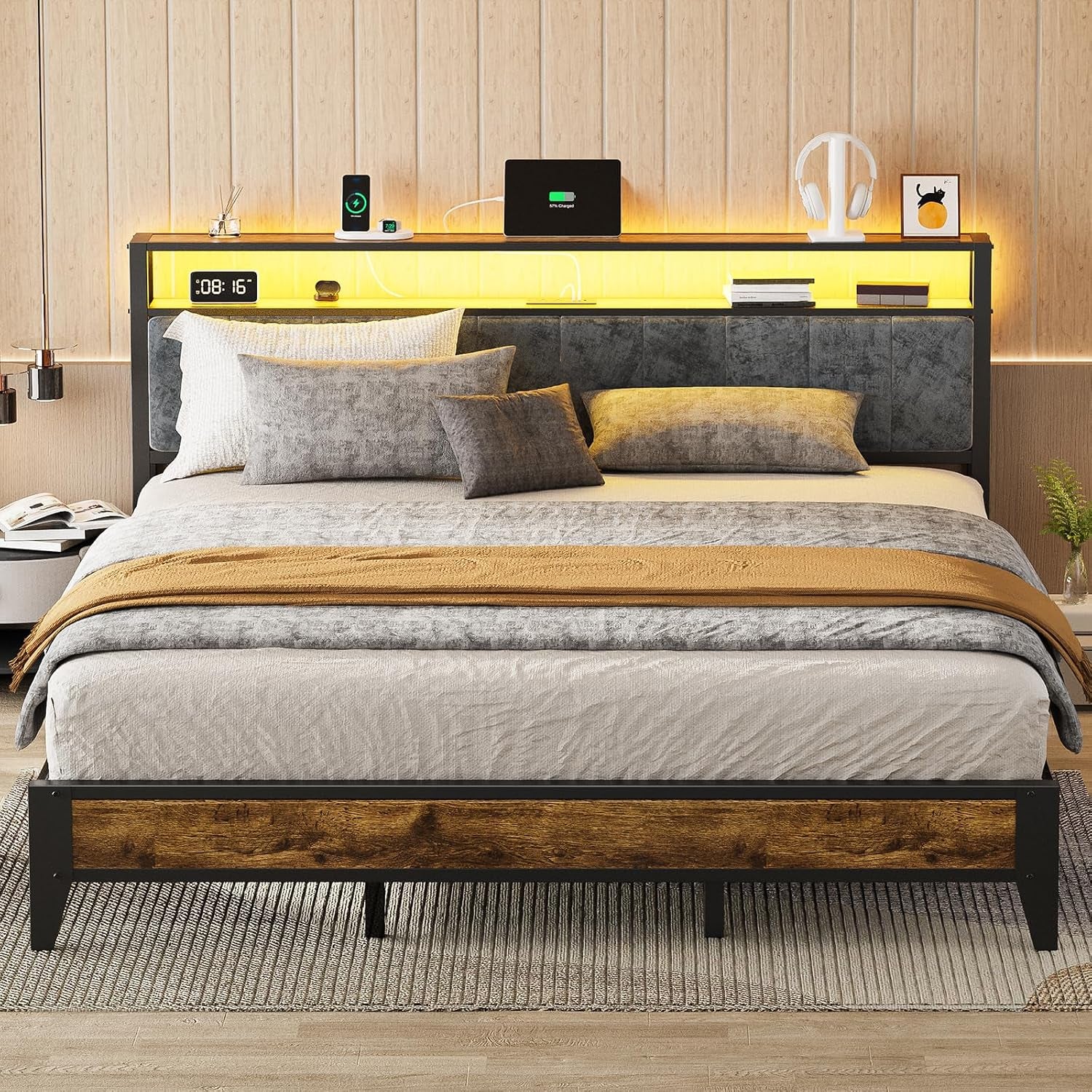 Centered bed with warm yellow LED headboard shelf, gray bedding and mustard throw, wood-accent footboard on a rug.