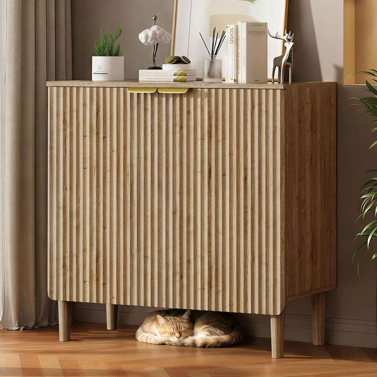 Three-quarter front view of a walnut cabinet with rounded corner, vertical fluted front and slim gold top handles.