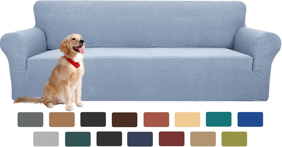Long sofa covered in a pale blue textured slipcover with a golden retriever sitting in front.