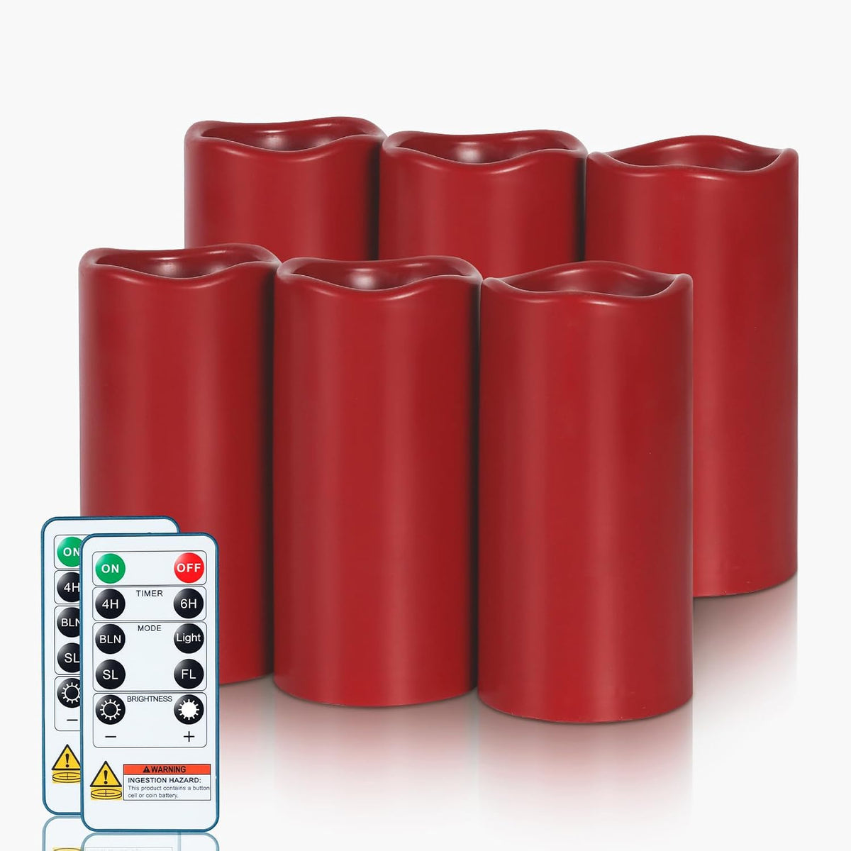 Six unlit red resin pillar candles grouped in two rows with two remote controls partially visible at the lower left.