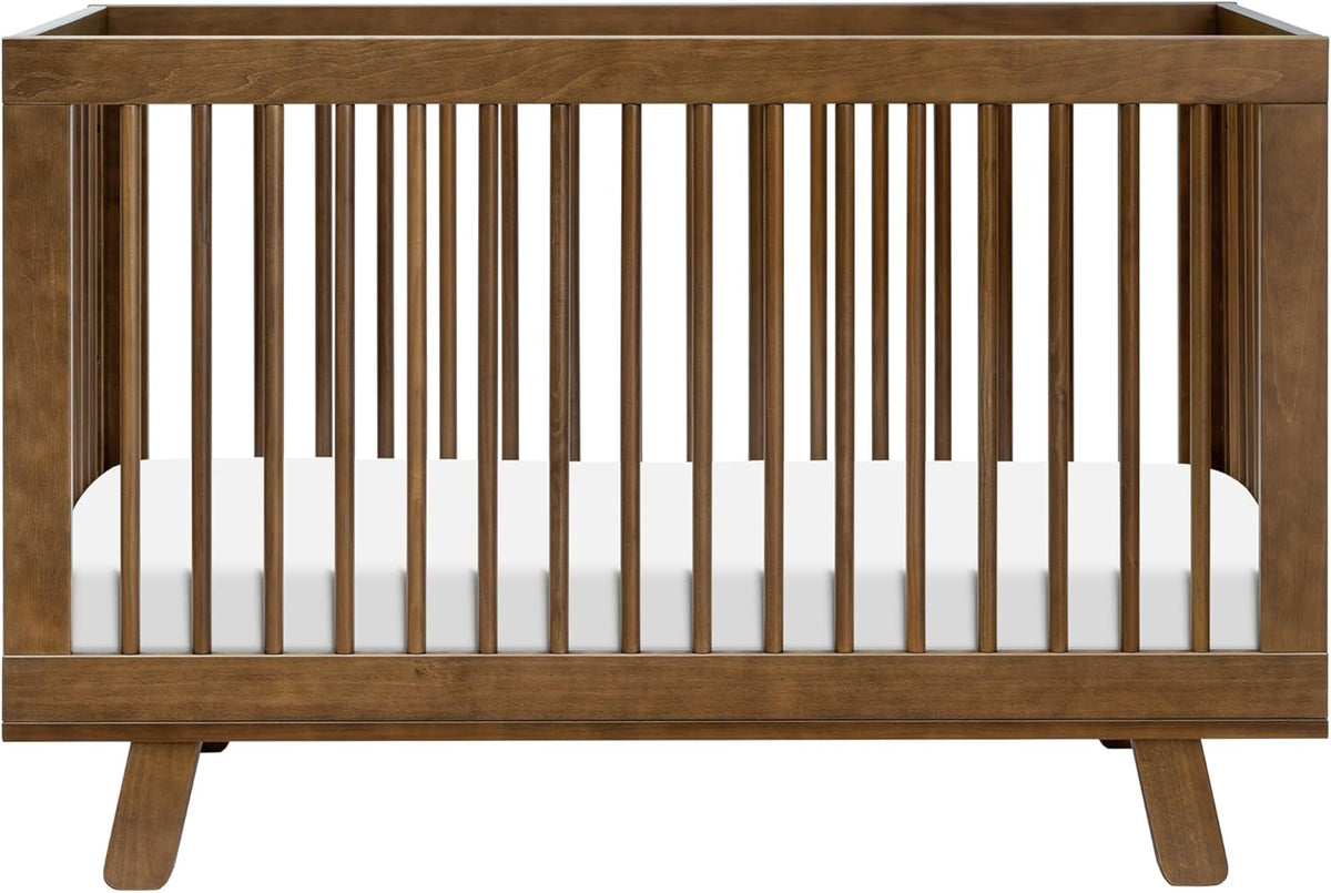 Front view of a dark brown wooden baby crib with vertical slats and angled legs.