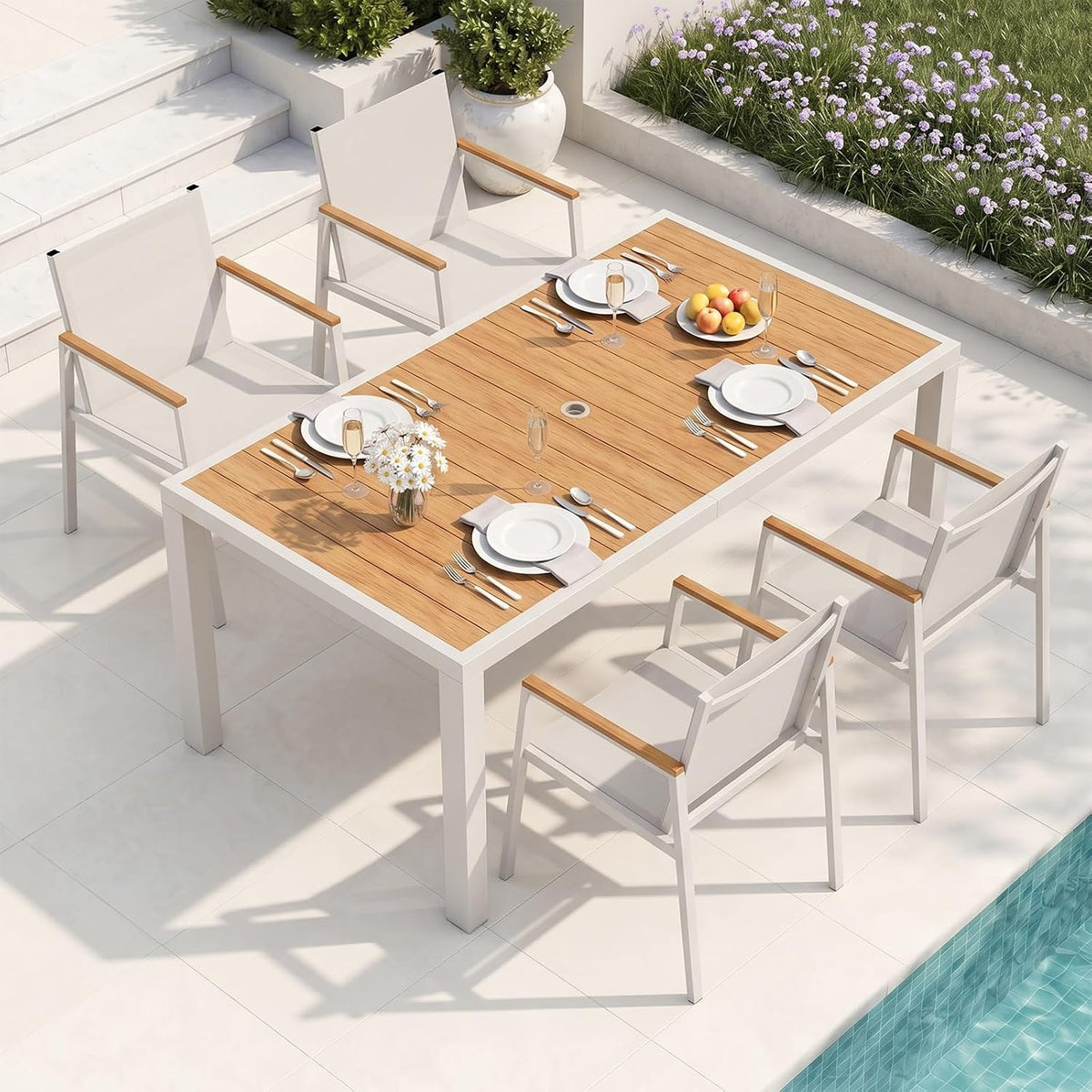Patio dining setup with a white-framed table and warm teak-look slat top paired with white chairs.