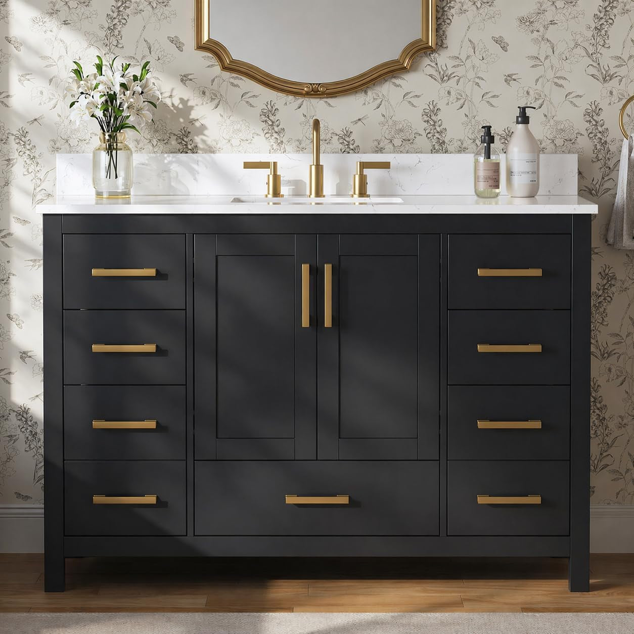 Front view of a dark bathroom vanity with gold hardware, central doors and multiple drawers.