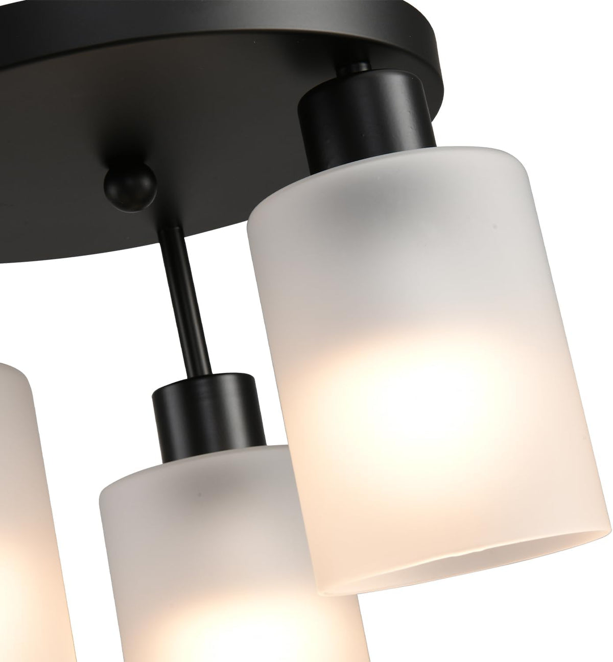 Macro close-up of the frosted glass shade and black metal mounting hardware on the three-light fixture