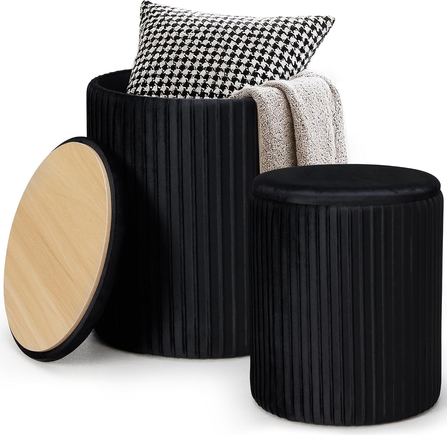 Two round black velvet ottomans, one open showing wood lid leaning and the other closed.