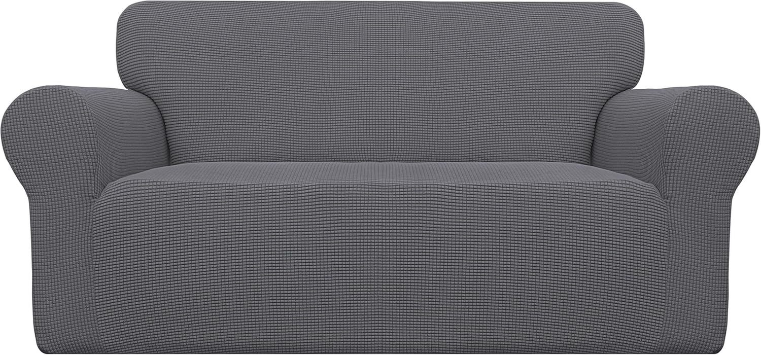 Cropped frontal view of a gray textured slipcover stretched evenly across the back, arms, and seat.