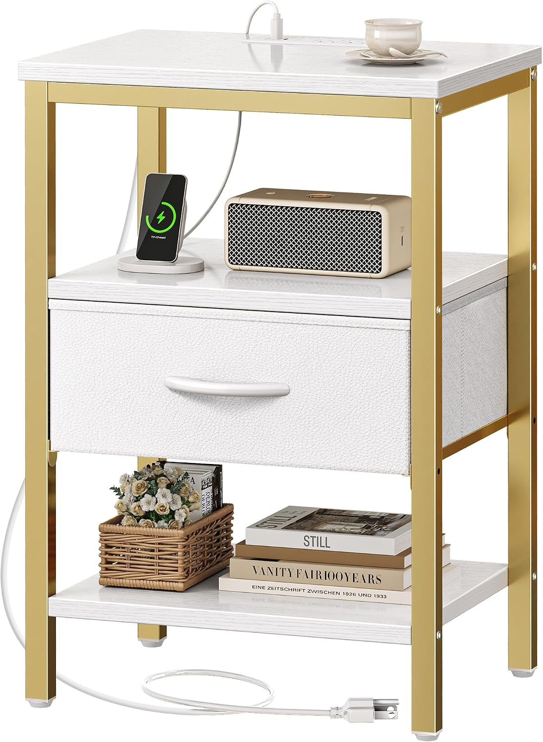 White top nightstand with gold frame, white fabric drawer, open middle shelf and charger on top