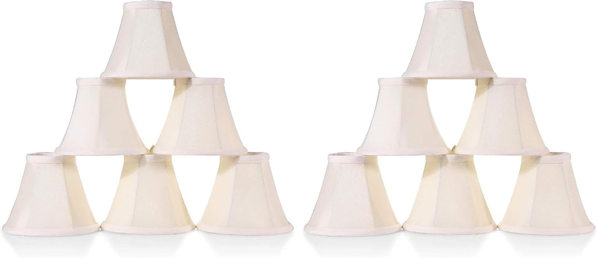 Two identical pyramids each made from six light-colored small lamp shades stacked in a triangular formation.