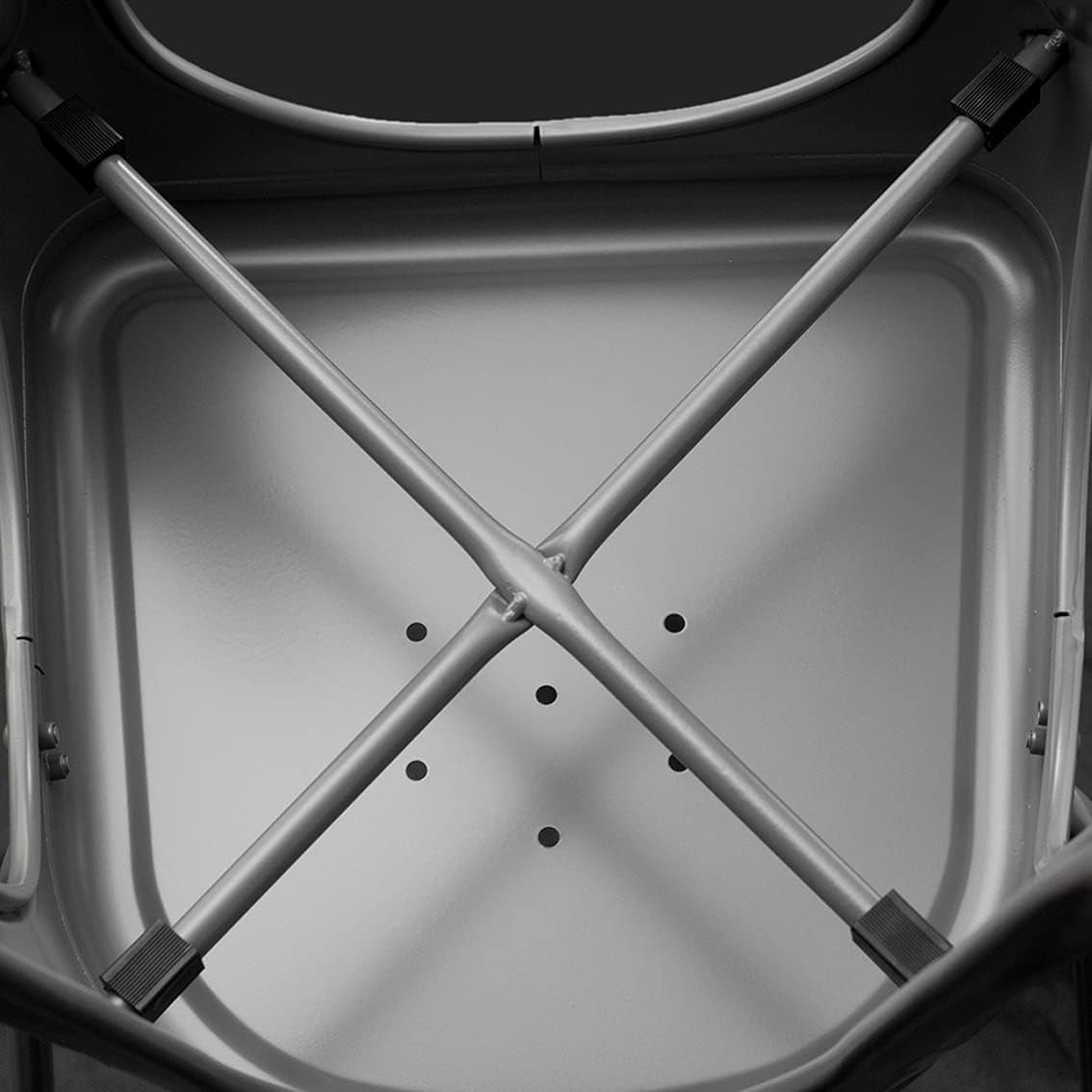 Underside of the chair seat showing crossed metal support bars and drainage holes.