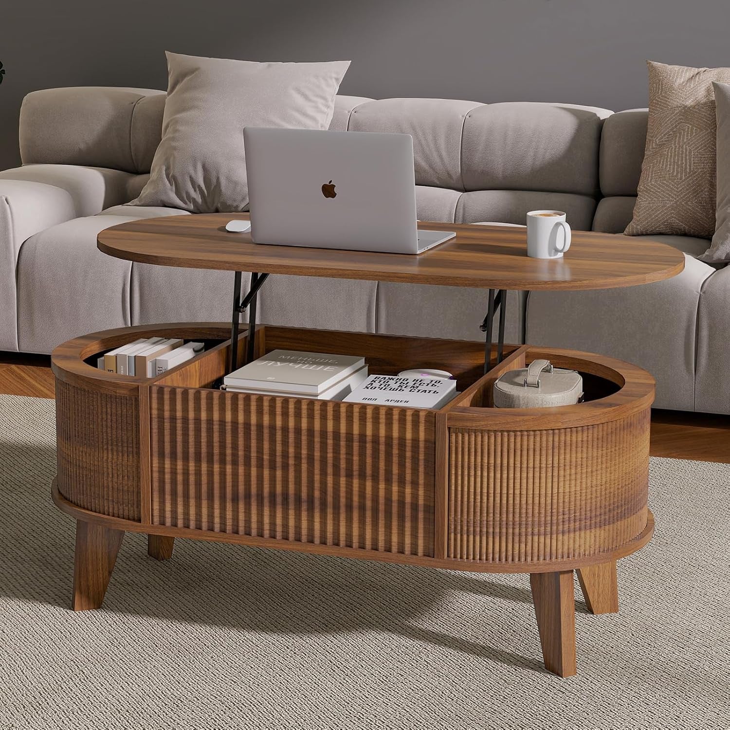 Walnut finish oval lift-top coffee table open to show hidden storage with laptop on raised top