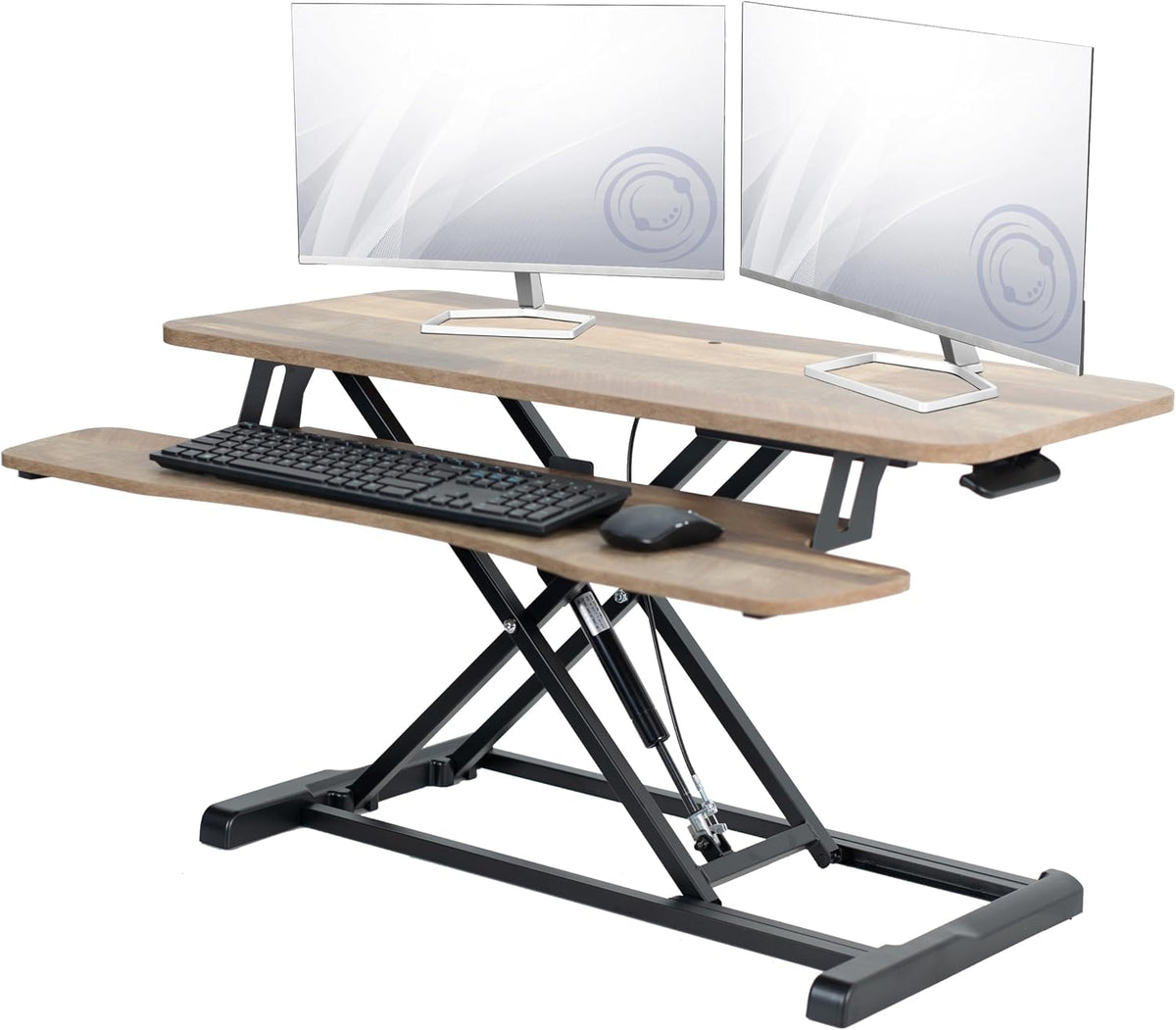 Angled view of the wood-grain converter in use with two monitors, keyboard, and mouse on tray