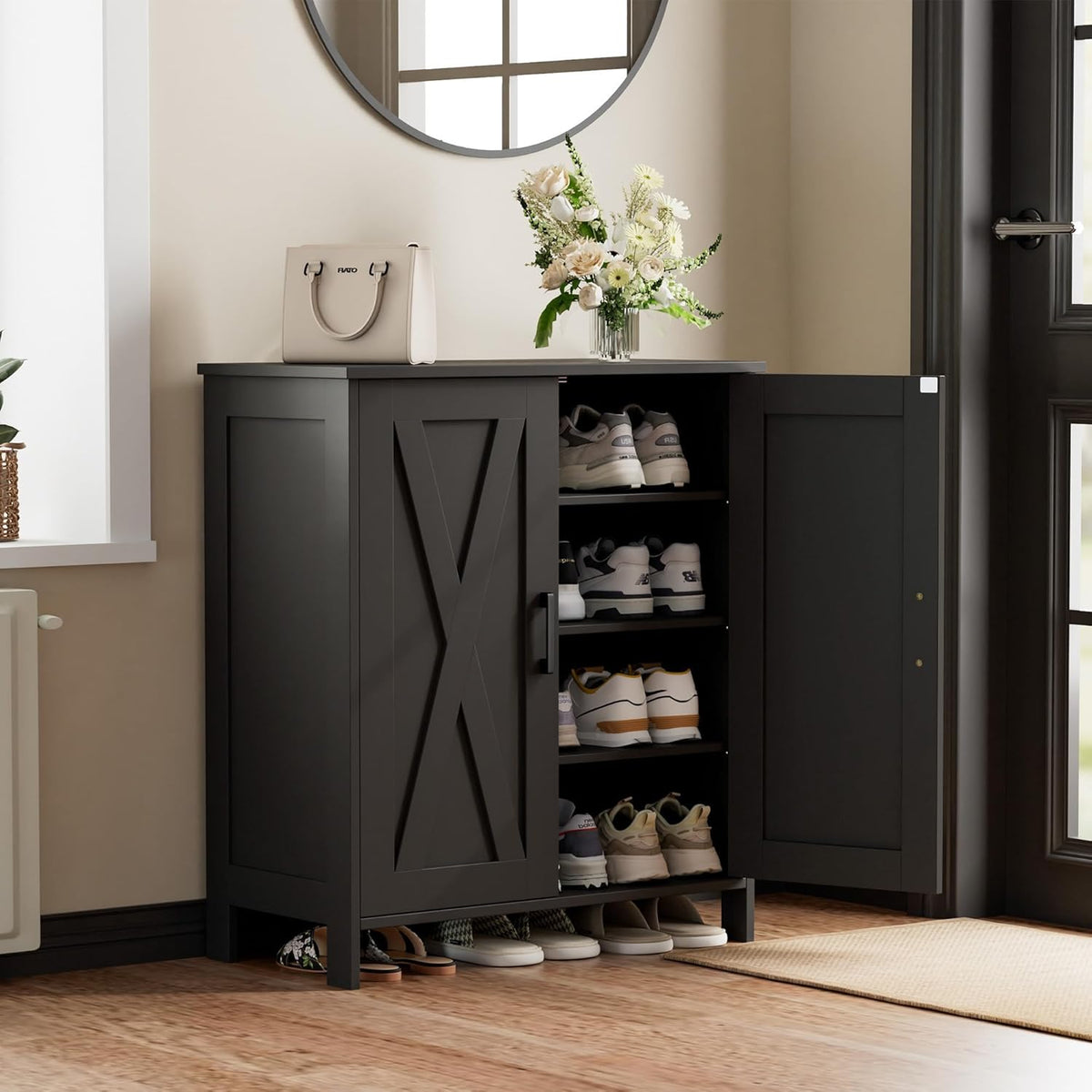Matte black shoe cabinet by a door, one door open showing stacked sneakers on interior shelves.
