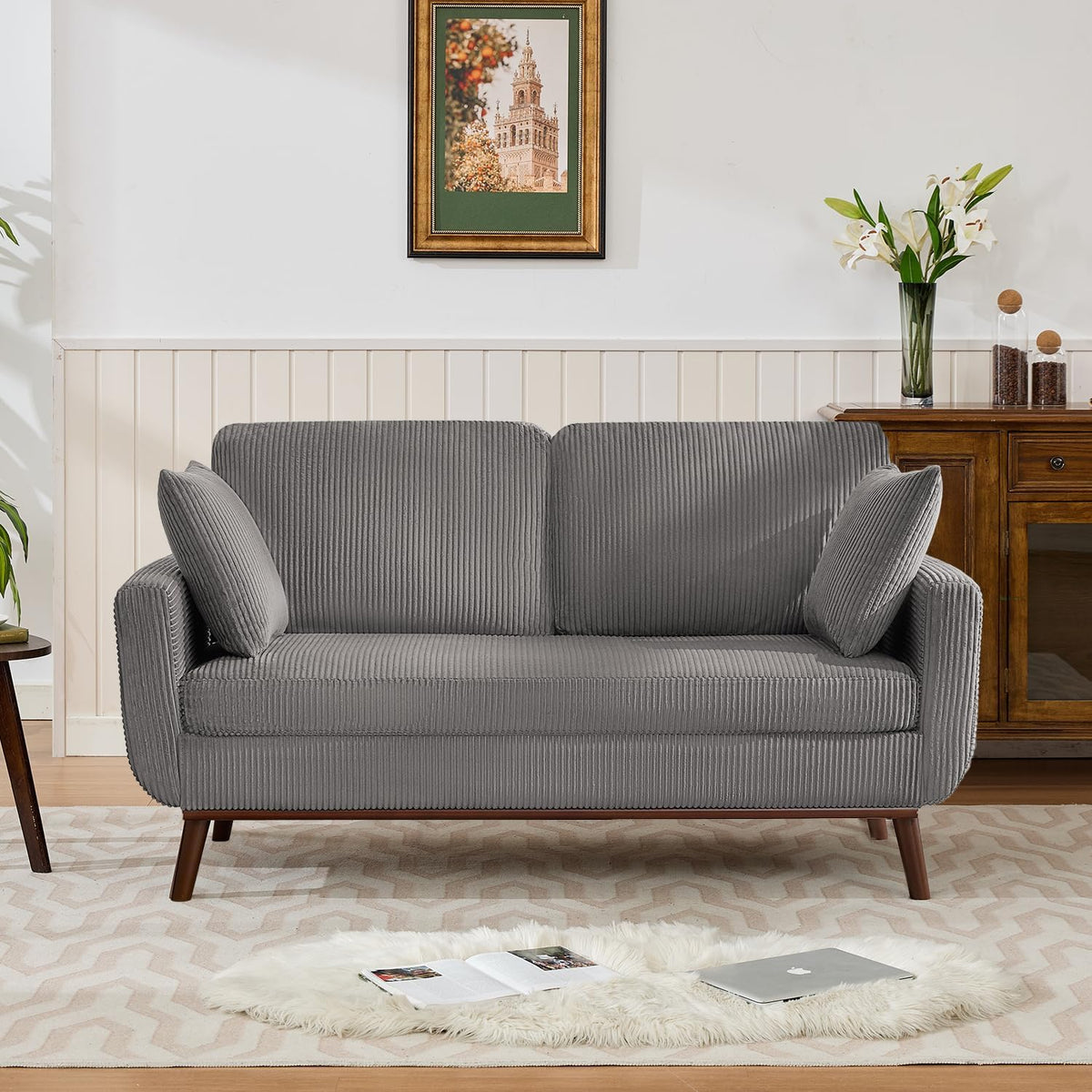 Front-facing gray ribbed-texture loveseat with two loose pillows and tapered wooden legs in a staged interior.