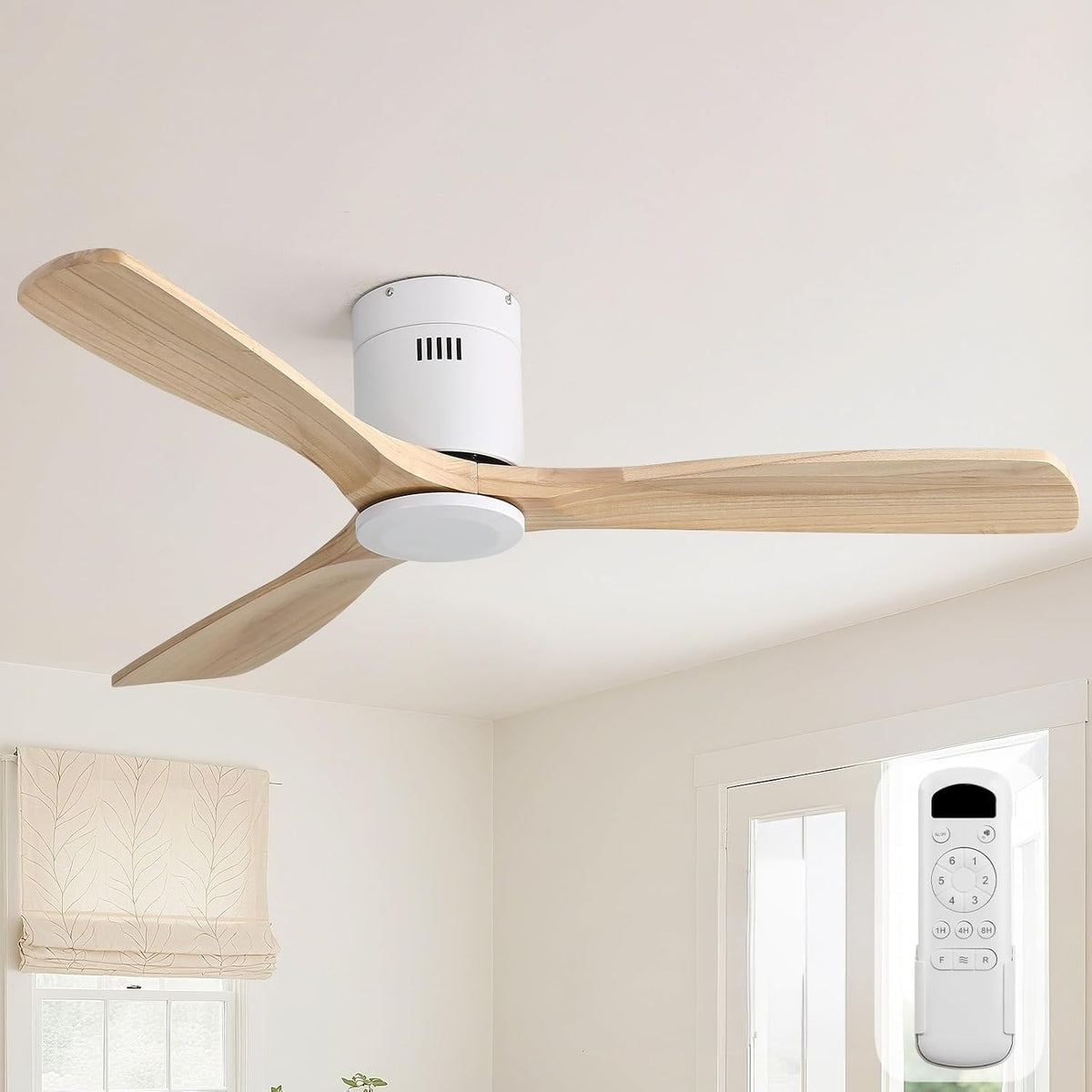 Installed three-blade ceiling fan with light, light natural wood blades and white motor mounted on a living room ceiling
