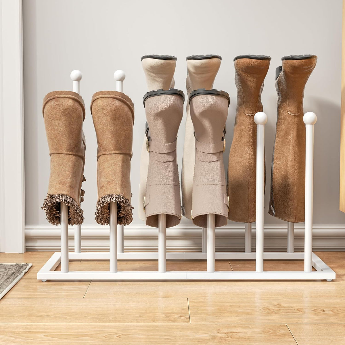 Straight-on view of a white boot rack showing eight vertical posts with boots placed over them against a baseboard.