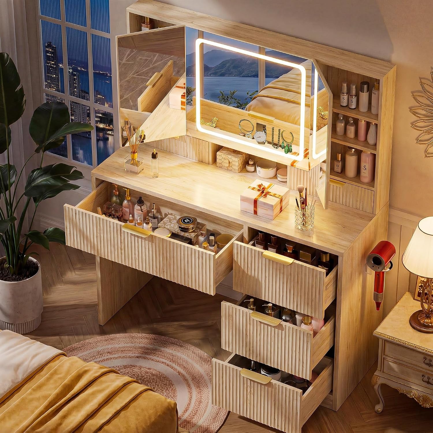 Angled view of the vanity with multiple drawers pulled out and mirror panels open showing storage
