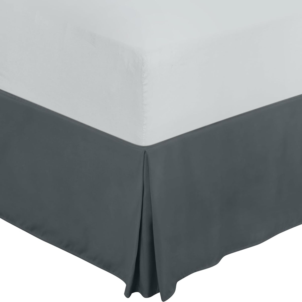 Top-down view of a dark gray pleated bed skirt with neat center pleat at the corner.