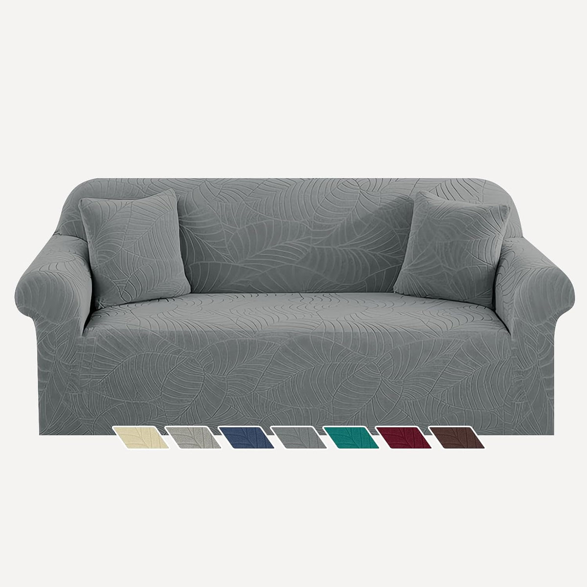 Three-seat sofa in gray leaf-patterned slipcover with two matching square pillows on a plain background.