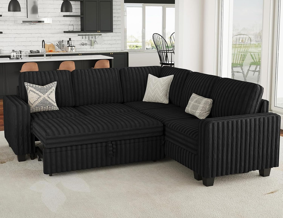 Black corduroy sectional in a corner layout with kitchen visible behind and three accent pillows