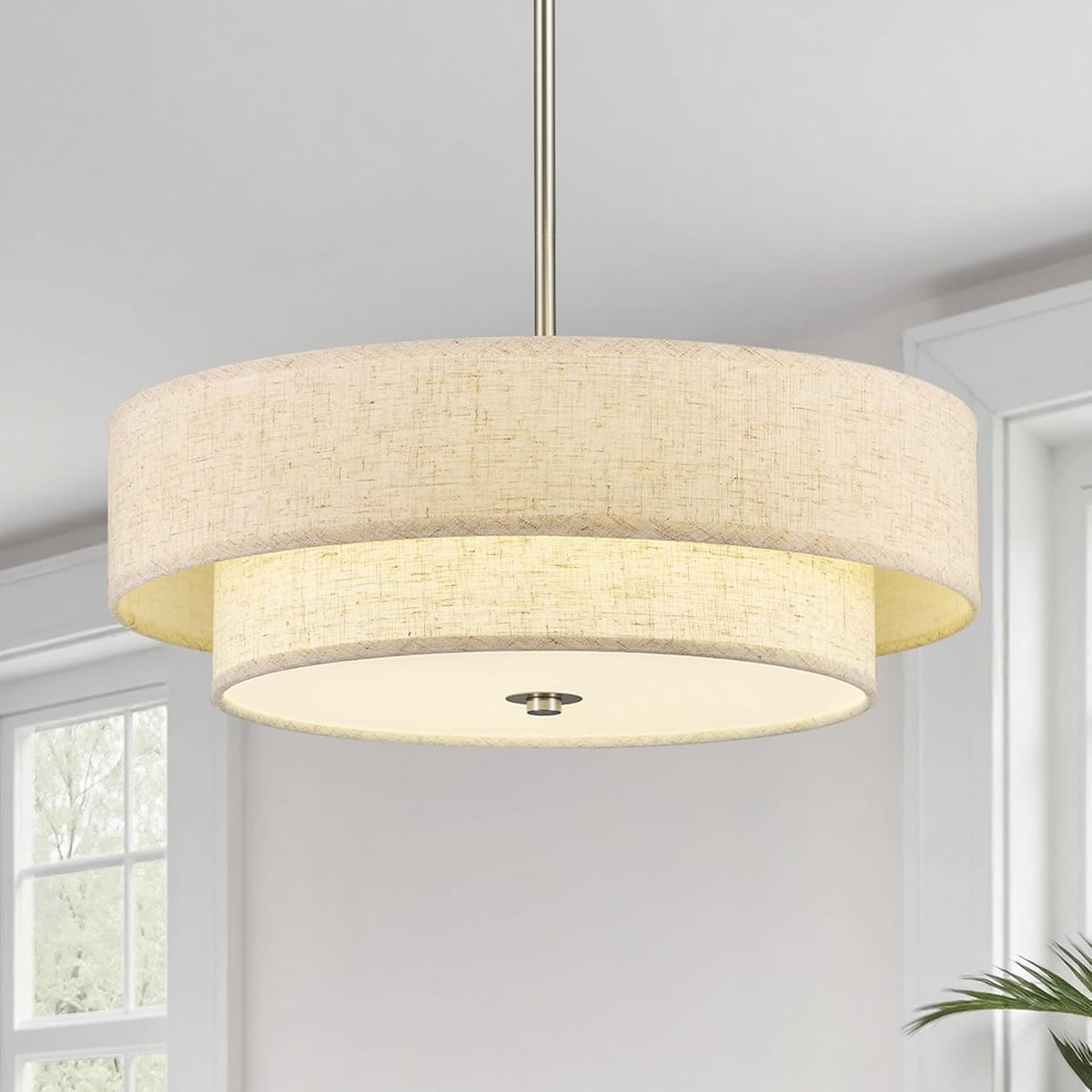 Close view of the linen texture on the double drum shade with a centered diffuser and silver-toned rod.