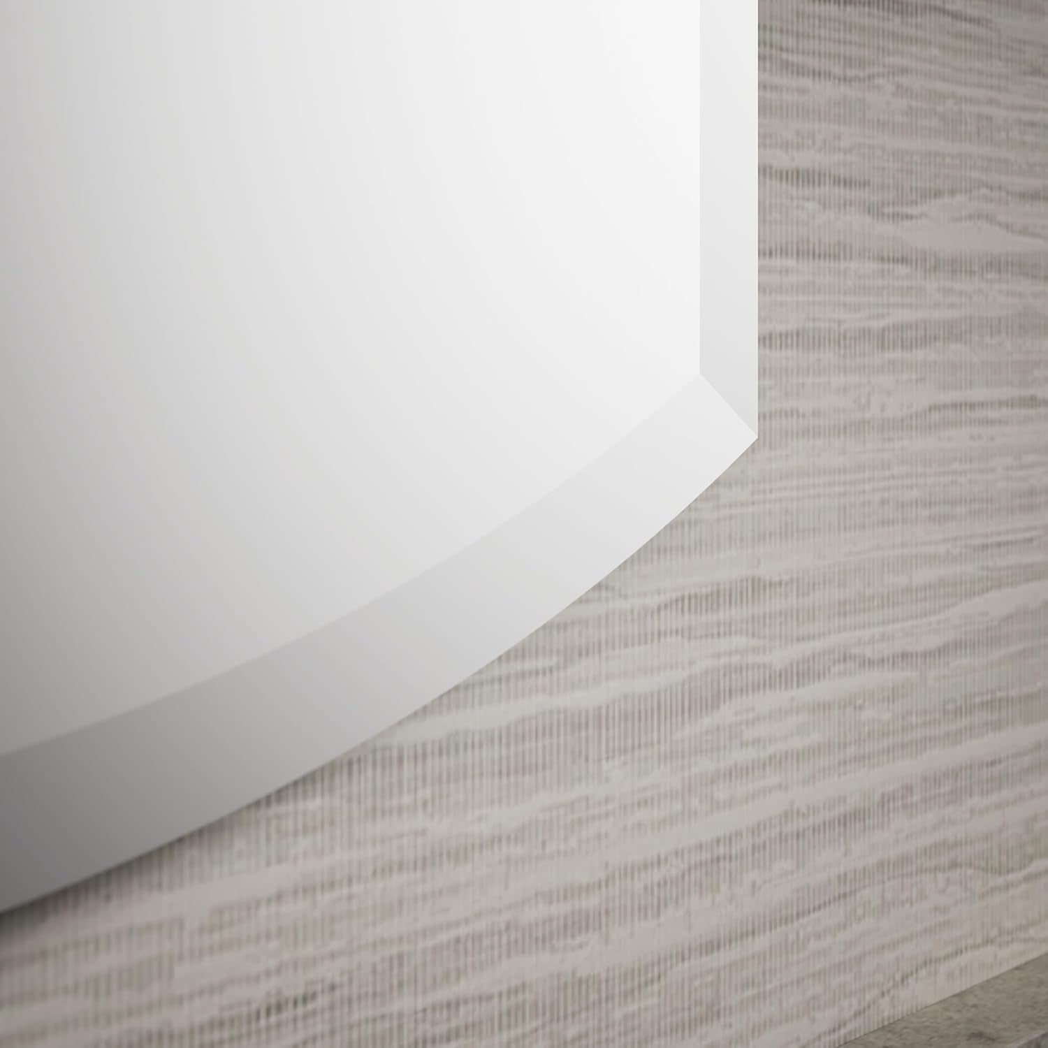 Close-up of the lower beveled edge and chamfer detail of the arched mirror against textured wallpaper