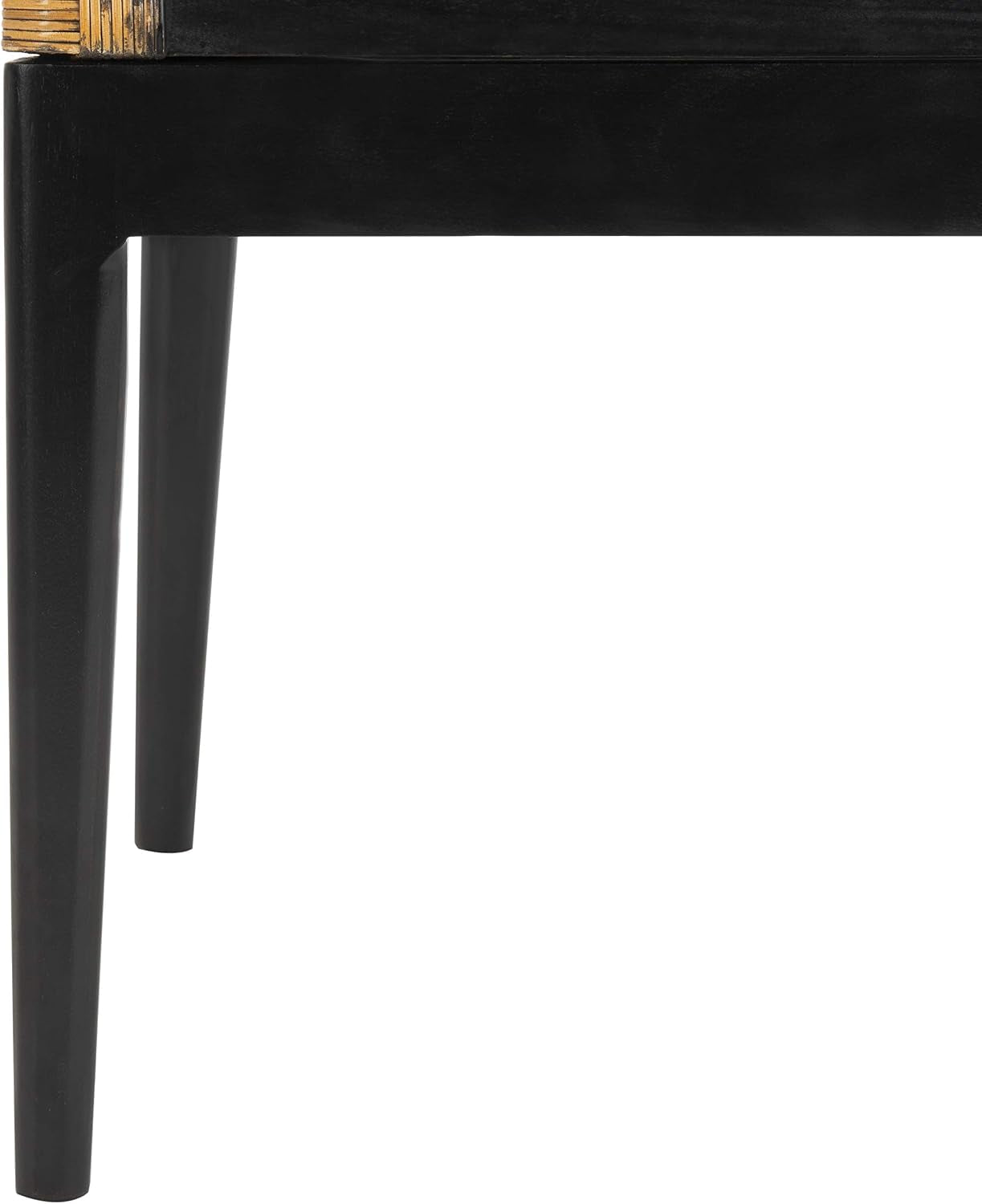 Close-up of a tapered dark wood chair leg and apron against white background.