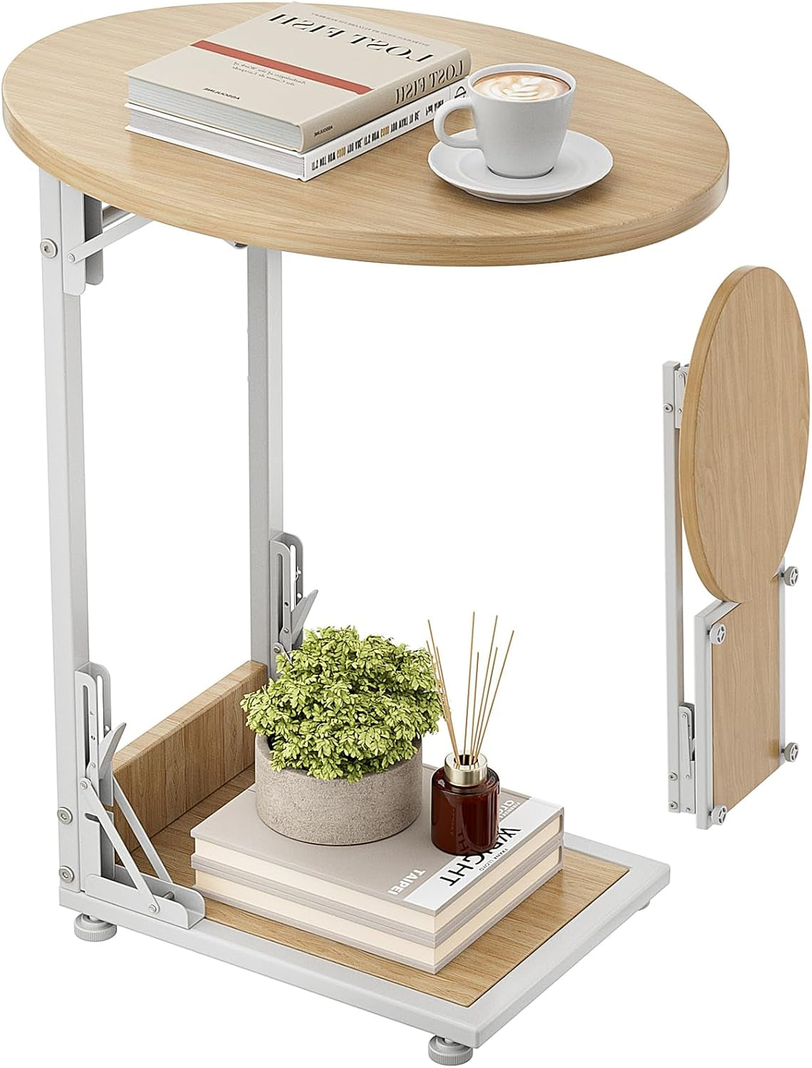 Light wood C-shaped folding side table with round top, lower shelf, and decorative books and cup