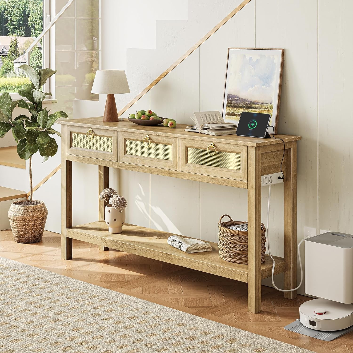 Angled view of the light oak console under a staircase with a tablet on top and parquet flooring
