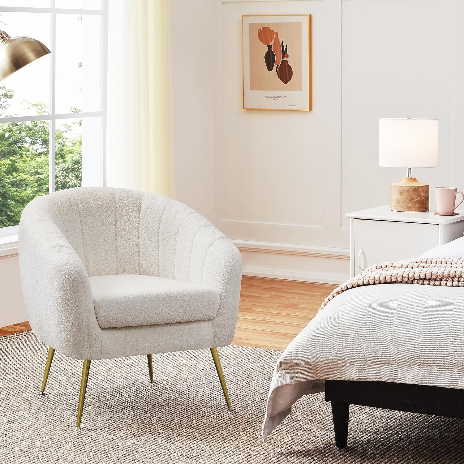 Ivory bouclé barrel accent chair angled front view in a bright bedroom setting